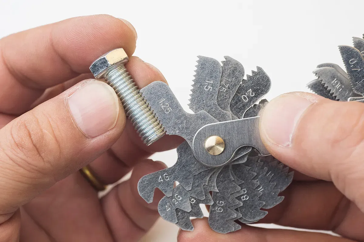 Thread gauge checking the thread of a bolt Thread gauge checking the thread of a bolt