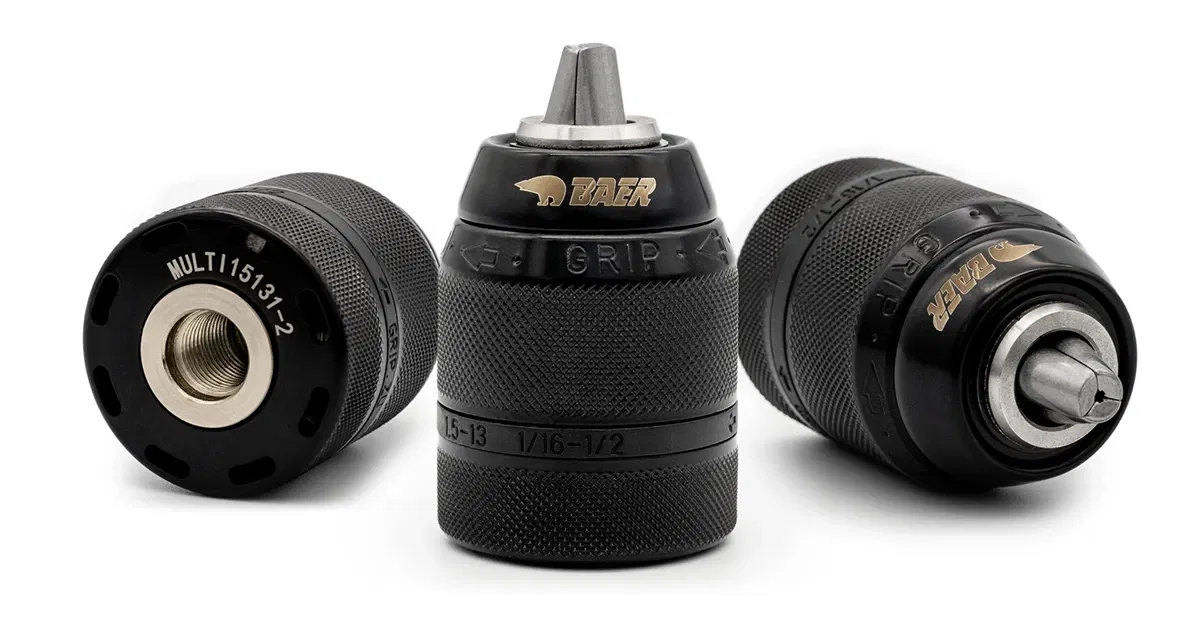 Three black drill chucks with knurled surfaces Three black drill chucks with knurled surfaces