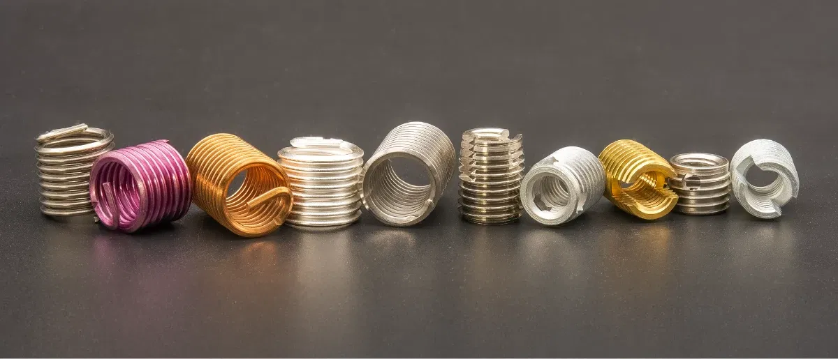 Assorted colored thread inserts in a row